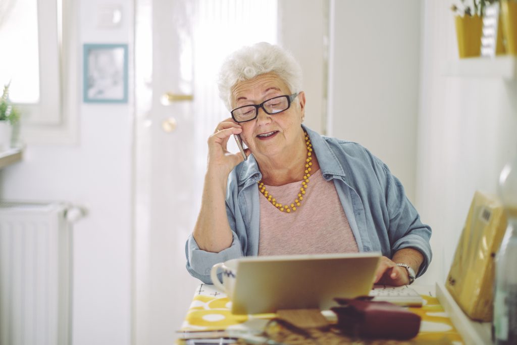 Neutral mature woman with phone iStock 1368188565