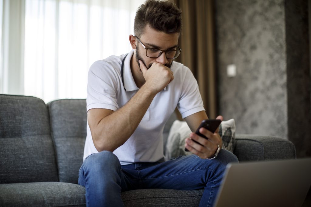 Serious younger man with phone iStock 1284992023 1
